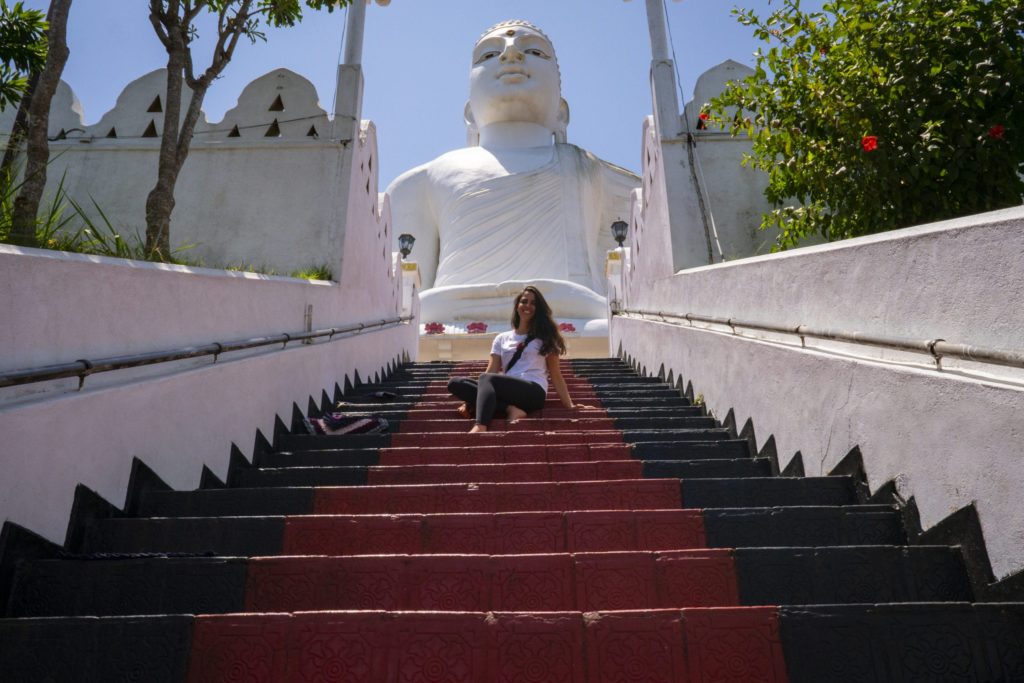 Student on the steps of a religious site in Sri Lanka