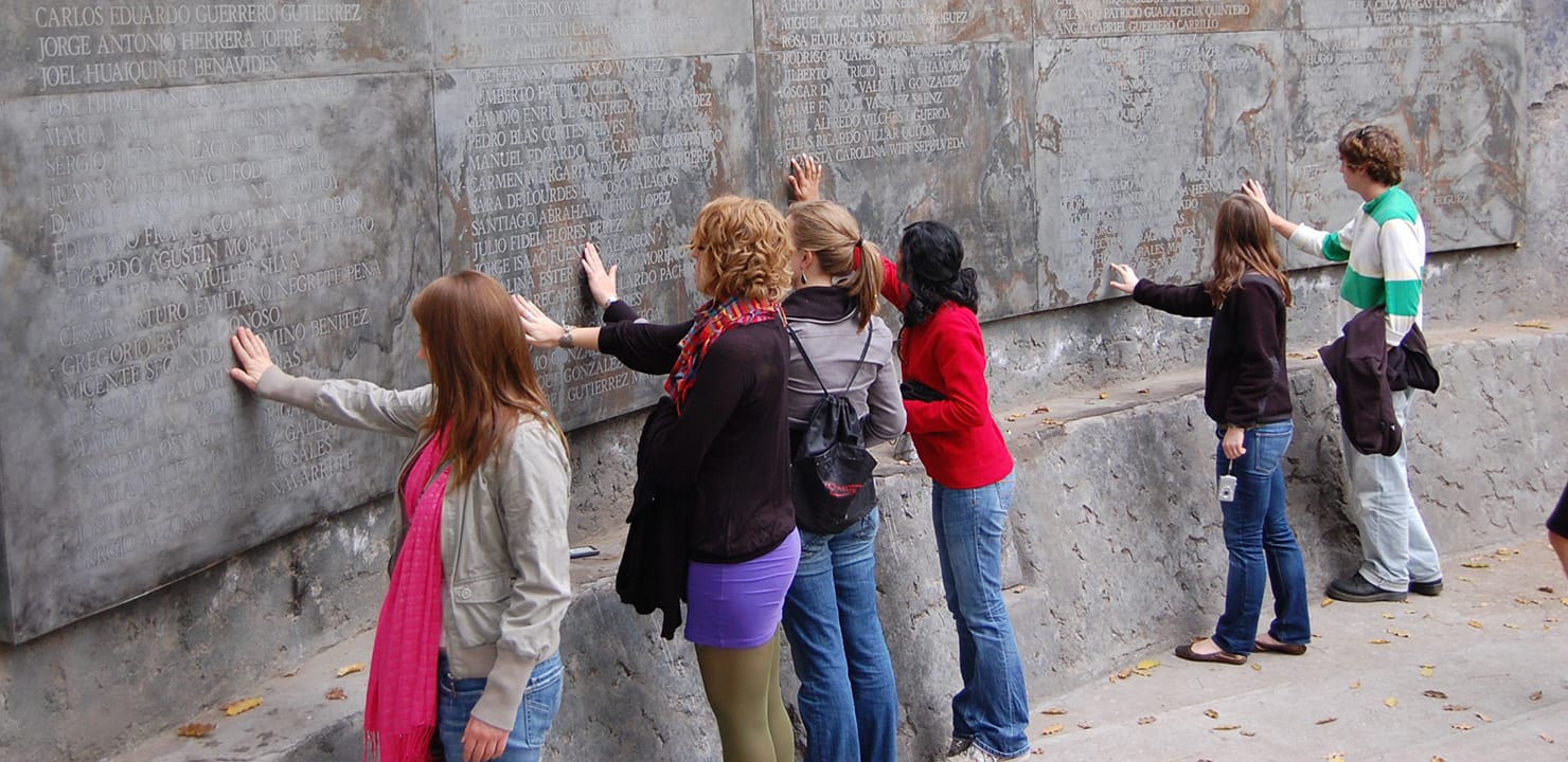 Students in front of a memorial wall.